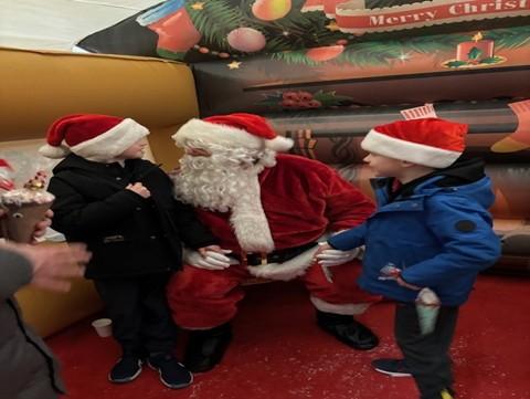 Santas meeting kids at Winterfest 2025